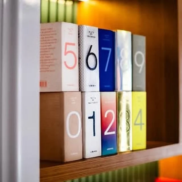 Colourful numbered boxes on a studio shelf
